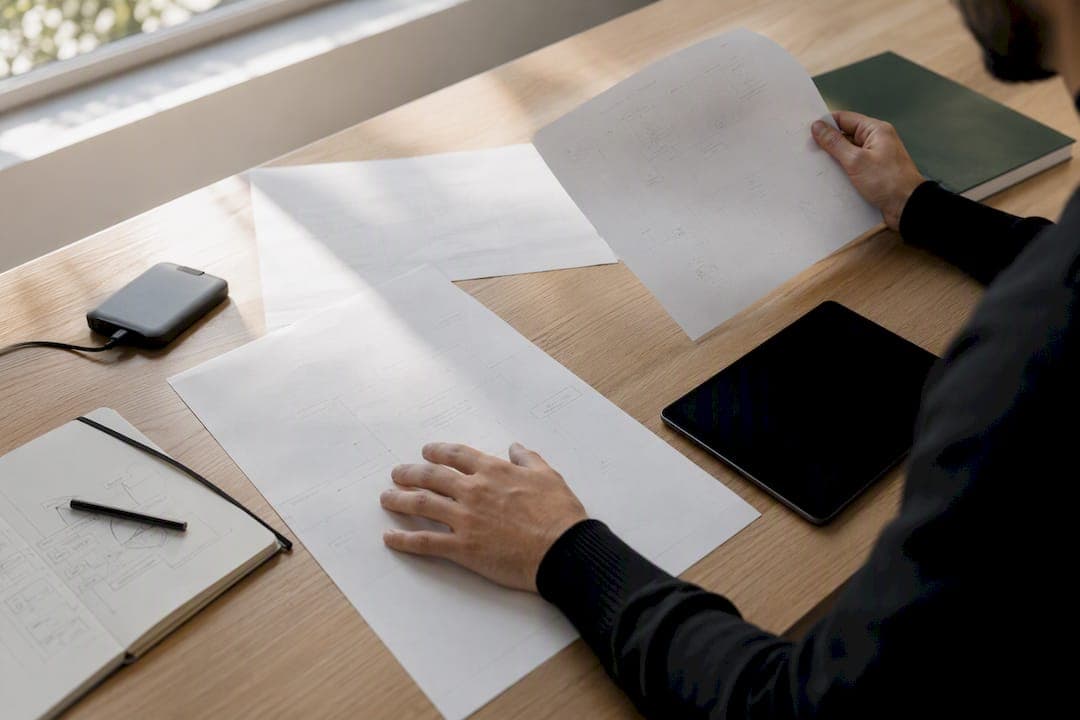 Hands validating data schemas on minimalist desk