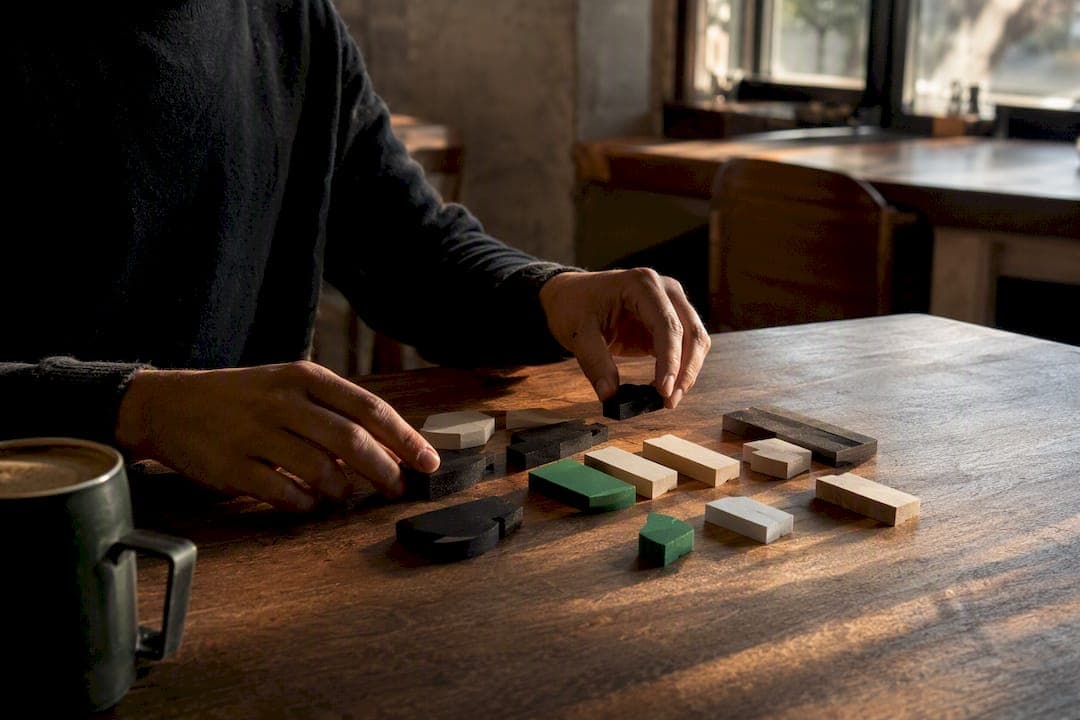 Hands arranging modular workflow tokens on desk