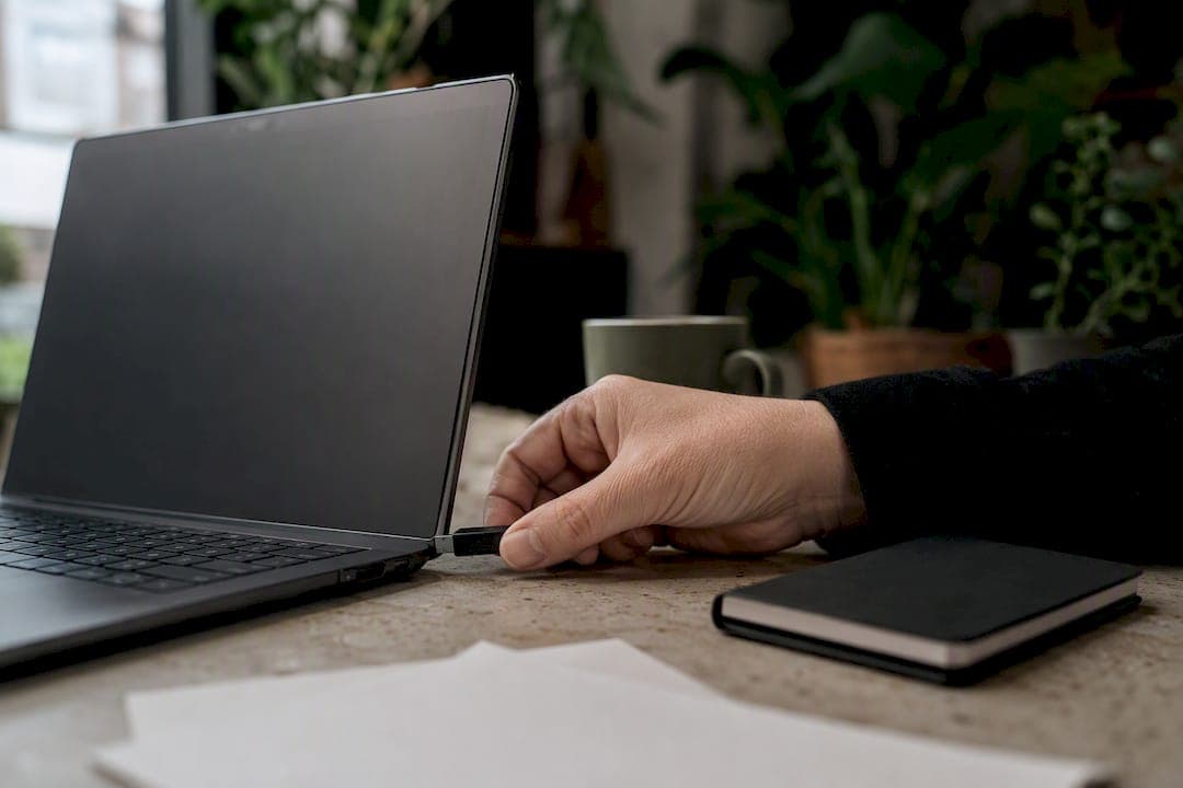 Hand plugging security key into laptop