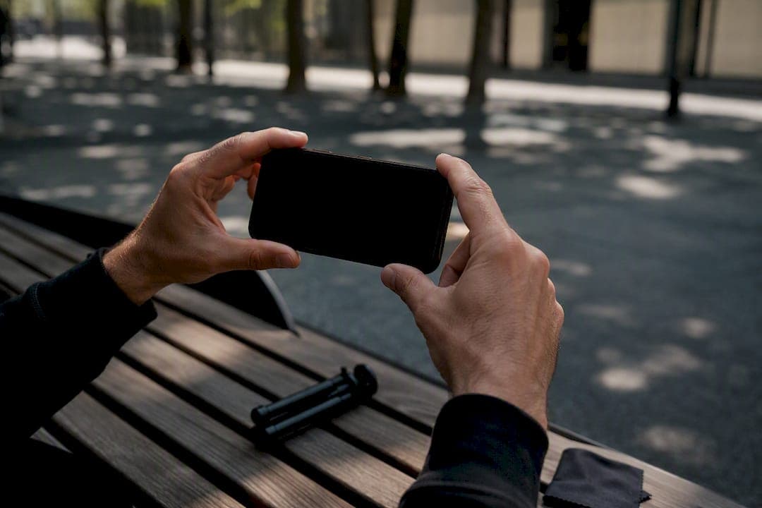 Hands adjusting smartphone camera framing